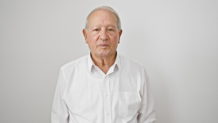Obraz premium Senior man standing with serious face over isolated white background