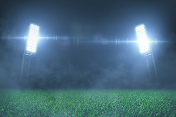 Football stadium with green grass lawn with shining spotlights at night with fog. Free space for...