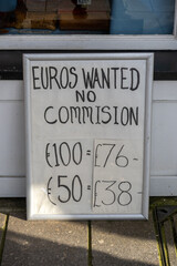 A notice board outside a shop says Euros wanted, no commission fees and displays the exchange rate