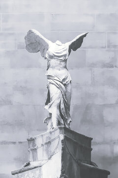 Winged Victory (Nike) of Samothrace, marble hellenistic sculpture in Louvre Museum. Cover page, monochrome, bnw. July 10, 2019. Paris, France