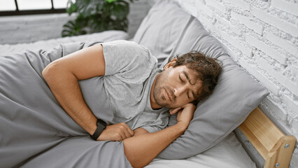 Hispanic man sleeping peacefully in a cozy bedroom with white brick wall and bedding