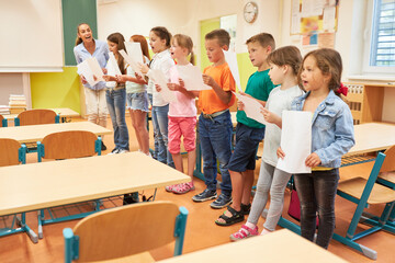 Fototapeta na wymiar School children singing song during choir practice
