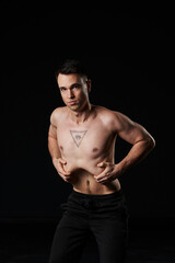  perfecting stomach vacuum, the man's chest tattoo of an all-seeing eye reflects his profound...