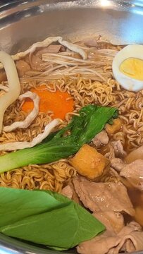 Korean foods served on a dining table. Perfect article, or any cooking contents. traditional hot pot combo, sweet garlic, and beef slices. It is very popular in sichuan