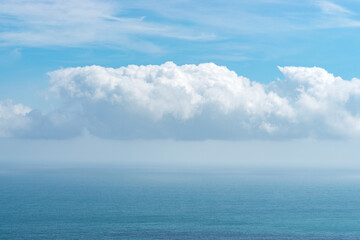 Naklejka na ściany i meble View of blue sea with dramatic cloudy sky.
