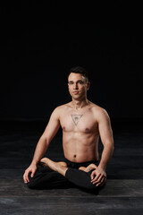 Engaged in lotus pose, stomach vacuum in progress, the man exudes tranquility with an all-seeing...