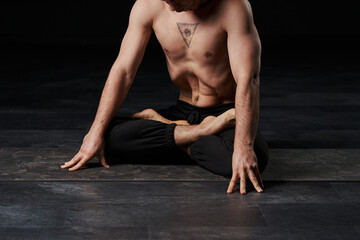 Lotus-posed man performs stomach vacuum, showcasing an all-seeing eye tattoo on his chest, radiating spiritual wisdom. - obrazy, fototapety, plakaty