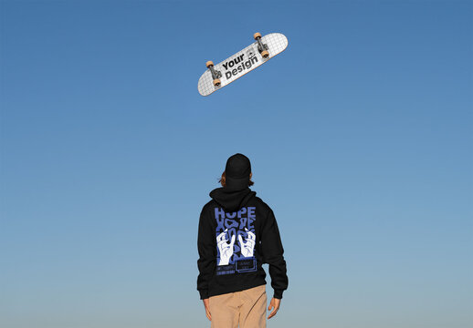 Mockup of customizable skateboard in sky, man in hoodie