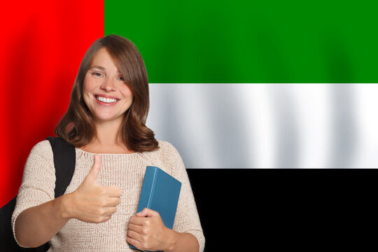 Smiling woman student against flag of United Arab Emirates background. Travel, education and learn language concept