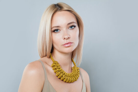Nice fashion jewelry model woman. Lady with fresh clean skin, blonde hair and necklace on her neck