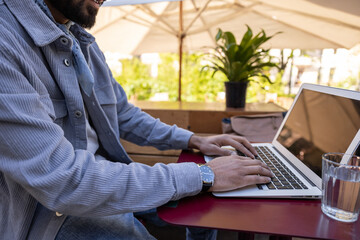 Hindu man working in a cafe and looking involved