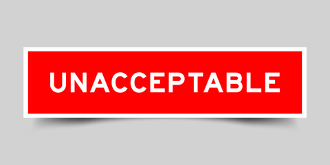 Square sticker label with word unacceptable  in red color on gray background