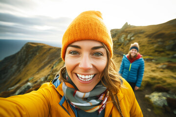 cheerful selfie with a landscape background on a cliff edge