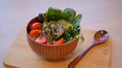 Tomato and greens bowl placed on the table. Bursting with tomato goodness, this dish radiates flavor This is an ideal choice for lunch. Delight in its freshness and health benefits with ripe, tomatoes