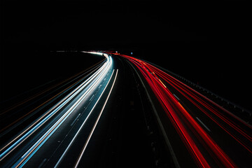 Fototapeta na wymiar Light trails on the highway at night. Rush hour on motorway with glowing cars headlamps, long exposure