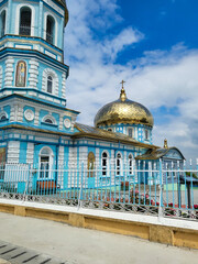 Orthodox church with blue facade and golden dome, Danube Delta, Romania