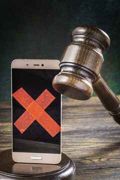 Judge gavel with a smartphone with a taped screen