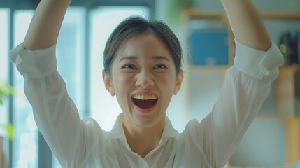 Excited young asian business woman celebrating successful financial project results, attracting...