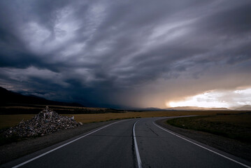 road mountains clouds storm sunlight sunset