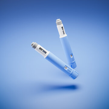 Two injectors / dosing pens  for subcutaneous injection of antidiabetic medication or anti-obesity medication hovering over a blue background.