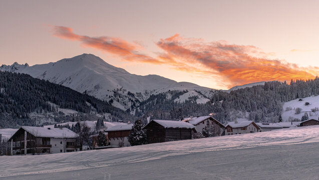 Orange sunset in the Swiss mountains, Disentis, Grisons, Switzerland. Mountain Village.
