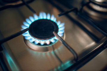 Burning gas fire flame on a kitchen gas stove.