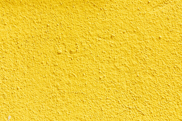 background of yellow background of a rough plaster wall