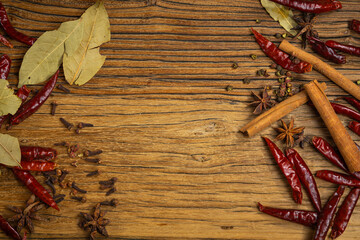 Dried red chili peppers on wooden background. Top view, copy space