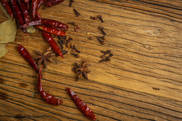 Dried red chili peppers on wooden background. Top view, copy space