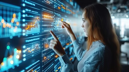 woman interacting with a futuristic glowing digital interface displaying various graphs and analytical data, suggesting a high-tech work environment.
