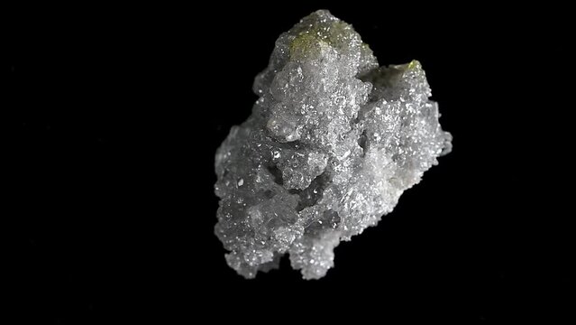 White Zincite Crystals [ ZnO2 - zinc oxide ], specimen rotating slowly against a black background.	