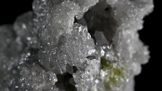 White Zincite Crystals [ ZnO2 - zinc oxide ], specimen rotating slowly against a black background.	