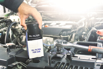 New oil filter unbox of the car and oil filter wrench for engine oil system maintenance in the...