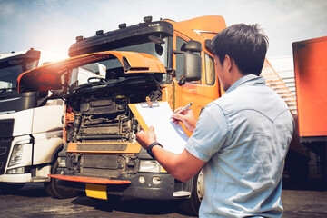 Asian Truck Driver is Checking the Semi Truck's Engine Maintenance Checklist. Lorry Driver....