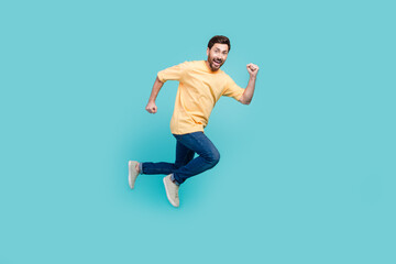 Fototapeta na wymiar Full body length photo of active guy brunet boyfriend running away from his ex girlfriend home isolated on aquamarine color background
