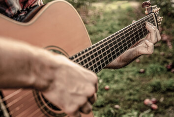 Music lifestyle man playing guitar nature concept. Hands of man musician playing guitar. Music...