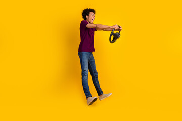Photo of crazy funky guy fly air look empty space simulate driving fast new car isolated on yellow color background