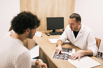 Doctor reviewing x-ray results with patient in office