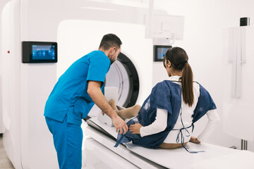 Female patient receiving assistance for MRI scan