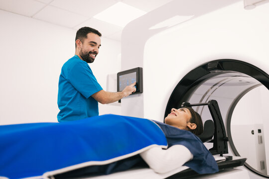 Radiologist preparing patient for a CT scan procedure