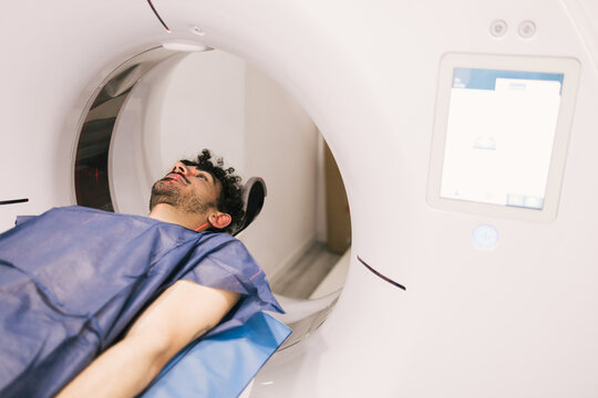 Man undergoing a CT scan in a medical facility