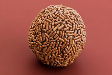 brigadeiro, brazilian sweet snack dessert on a brown background