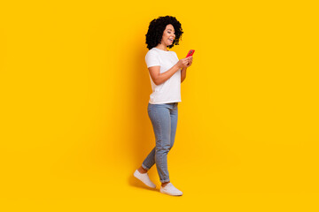 Fototapeta na wymiar Full length photo of pretty sweet woman wear white t-shirt texting apple iphone samsung modern device isolated yellow color background