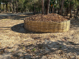 Big bamboo basket for pile of leaves  before bushfire season in rural asian.