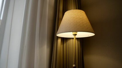 Decorative floor lamp in a hotel room. Illuminated lamp in the room. A beautiful floor lamp stands on the floor in a hotel.