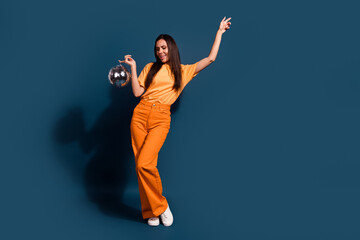 Full length photo of lady wearing orange apparel have festive mood in night club with disco ball...