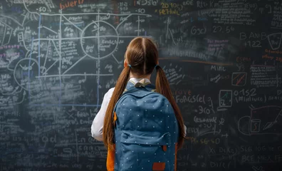  Teenager in class on background of blackboard © Konstantin Yuganov