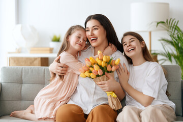 daughters and mom with flowers - obrazy, fototapety, plakaty
