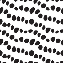 Pebble like black spots diagonally lined in seamless pattern. Black stones repeated in rows on white background. Minimal surface art for printing on various surfaces or usage in graphic design 