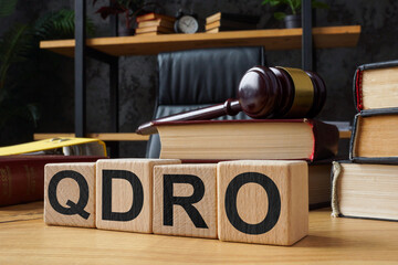 Table and cubes with abbreviation QDRO Qualified Domestic Relations Order.